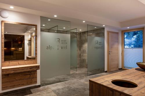 a bathroom with a glass shower and a sink at Apart Alpenjuwel Sölden in Sölden
