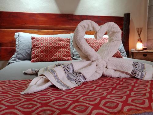 a bed with two swans made out of towels at Nelumbo Petit Chalet in San Rafael