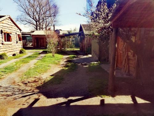 an empty yard with a house and a building at Cabañas Monje in Tandil