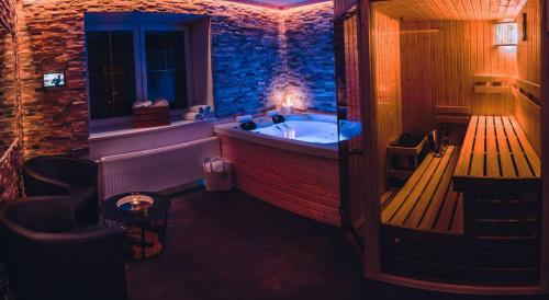 a bathroom with a tub in a room with a window at Apartmány Jedovnice in Jedovnice