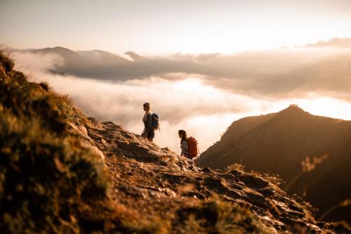 two people standing on top of a mountain at Laube35 Central City Apartments in Vipiteno