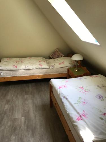 a room with two beds and a lamp on a table at Andrea-OG in Büsum