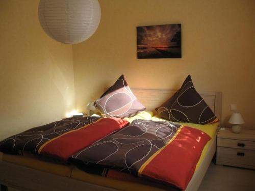 フロイデンシュタットにあるFerienwohnung-am-Foerstereckのベッドルームに枕が数個付いています。