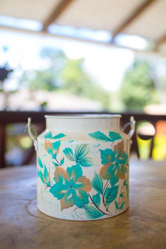 a cup with flowers on it sitting on a table at Akawanka Lodge in San Agustín