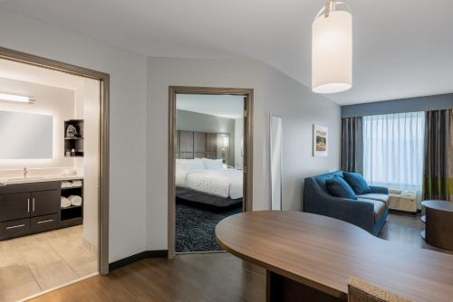 a living room with a bed and a table at Candlewood Suites Cookeville by IHG in Cookeville