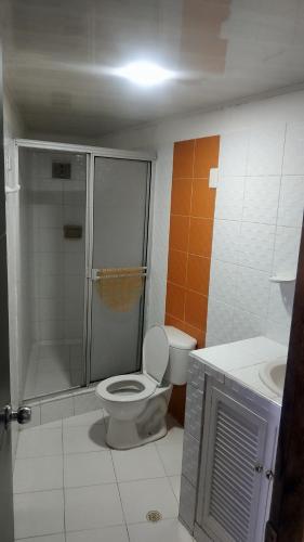 a bathroom with a toilet and a shower and a sink at Edificio Nuevo Conquistador in Cartagena de Indias