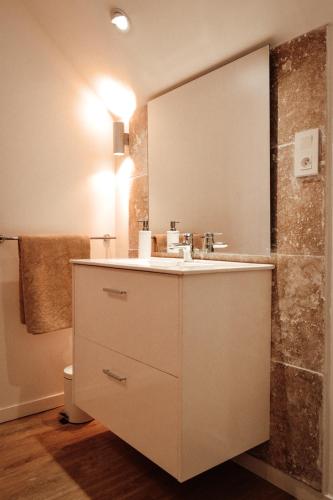 a bathroom with a sink and a mirror at Le Chai in Condom
