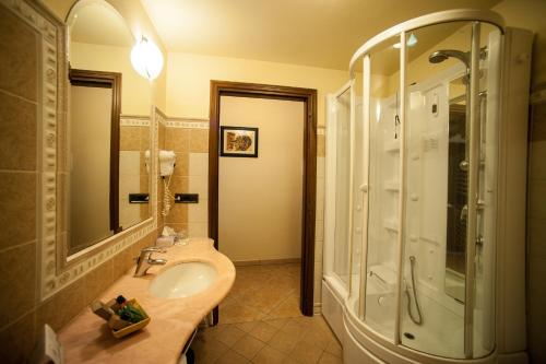 a bathroom with a sink and a shower at Hotel Corte Vecchia in San Prospero 