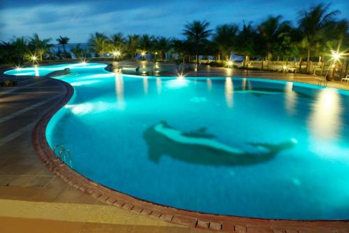 a large swimming pool at night at Seava Ho Tram Beach Resort in Ho Coc