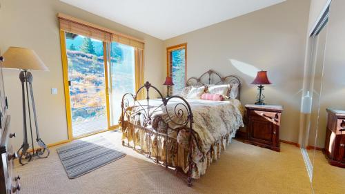 a bedroom with a bed and a large window at Snowcreek V #774 condo in Mammoth Lakes