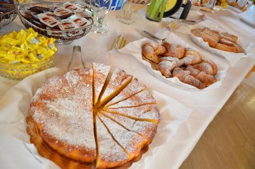 a table topped with bread and pastries and other foods at Hotel Corte Vecchia in San Prospero 