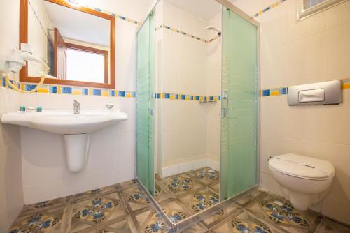 a bathroom with a sink and a toilet at White Hotel in Oludeniz