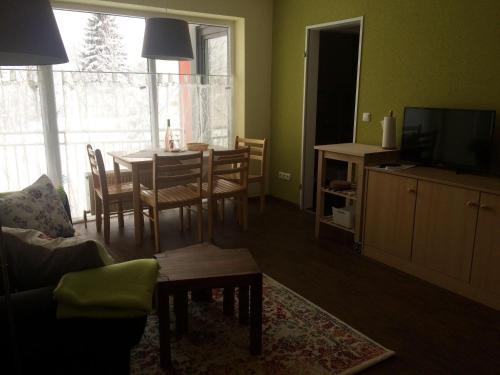 uma sala de estar com uma mesa e uma sala de jantar em Ferienwohnung-Koehler-2 em Altreichenau