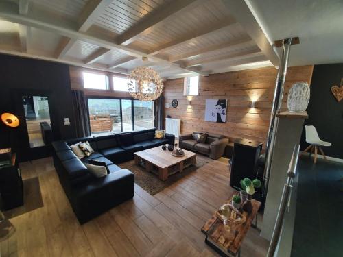 a living room with a couch and a table at Gîte Le Rivage in Stavelot