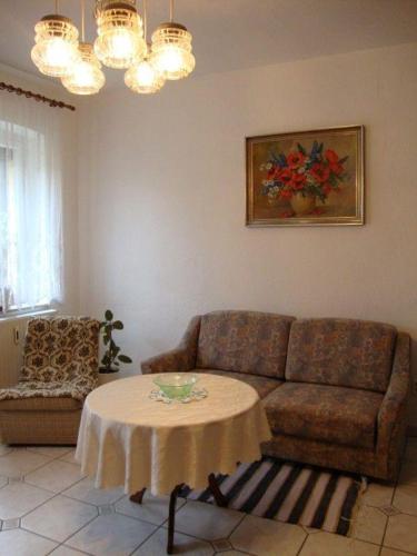 uma sala de estar com um sofá e uma mesa em Ferienwohnung-Dresden-Sued em Dresden