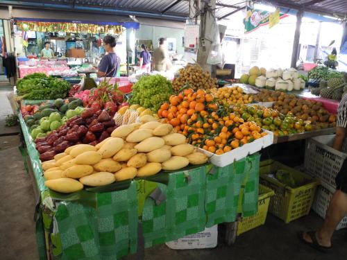 a display of fruits and vegetables in a market at Green House Phuket in Ban Pa Khlok