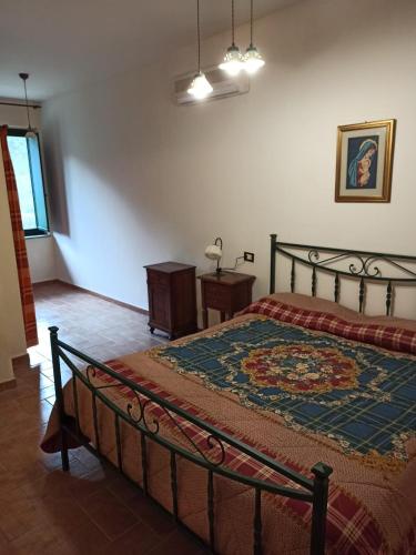 a bedroom with a bed with a rug on it at Tenuta Agrituristica Castellesi in Squillace