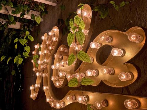 a large gold sign with a bunch of lights at The Diplomat Boutique Hotel in Mérida