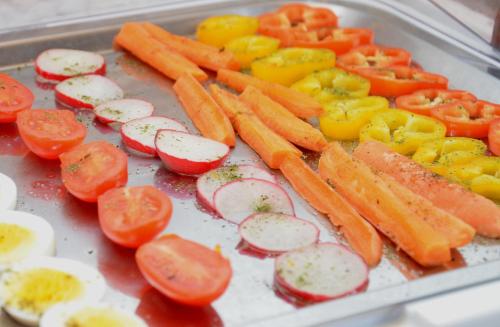 a tray with carrots and eggs and tomatoes on it at Kleintödlinggut in Leogang