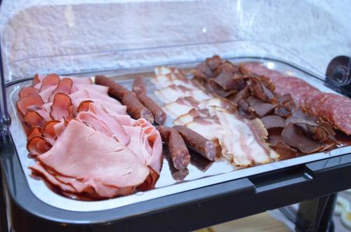 a tray of ham and other meats and sausage at Kleintödlinggut in Leogang