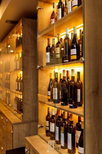 a bunch of bottles of wine on shelves in a room at Hotel IN in Banja Luka