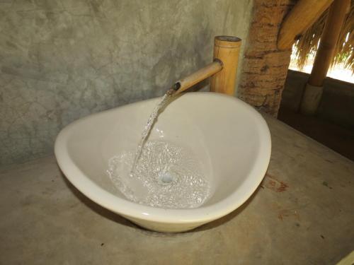 a white bowl with water pouring into it at Bel-Há Ecoparque in El Naranjo