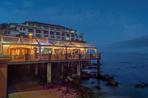 a building on a pier next to the ocean at Monterey Plaza Hotel & Spa in Monterey