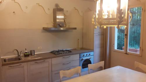 a kitchen with a sink and a stove top oven at Villa Simo in Portoferraio