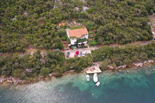 an aerial view of a house and boats in the water at Apartmani Jagoda in Lastovo