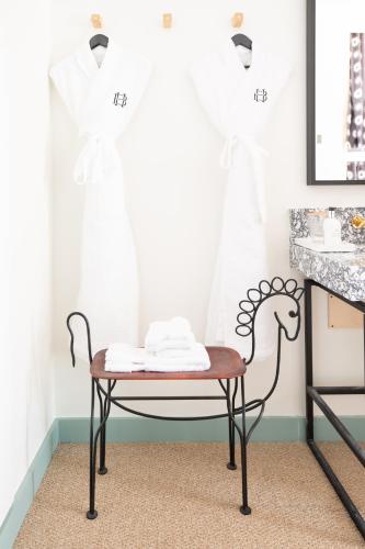 a room with a table and a chair in front of a window at Bradford House, a Member of Design Hotels in Oklahoma City