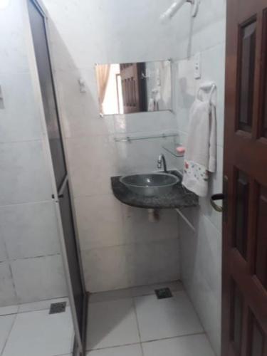 a small bathroom with a sink and a mirror at Donaldo Apartamentos in Alter do Chao