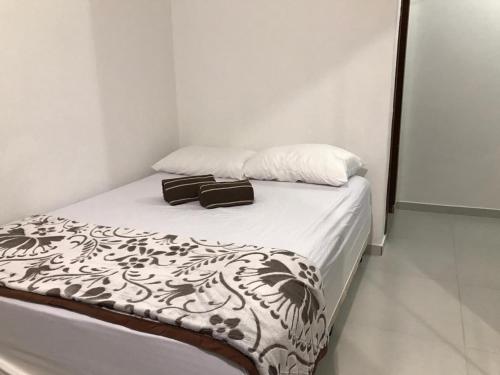 a bedroom with a bed with two bags on it at Casa Walter in Balneário Camboriú