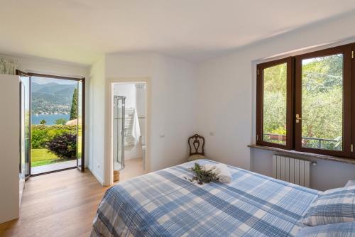 a bedroom with a bed and a view of a lake at Villa Margherita Portese in San Felice del Benaco