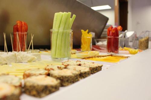 a table with some food and celery on it at Kapitaenshaus-Lassen-Zimmer-Kajuete in Westerland (Sylt)