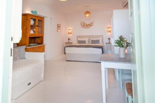 a bedroom with a bed and a desk at Villa Mando in Super Paradise Beach