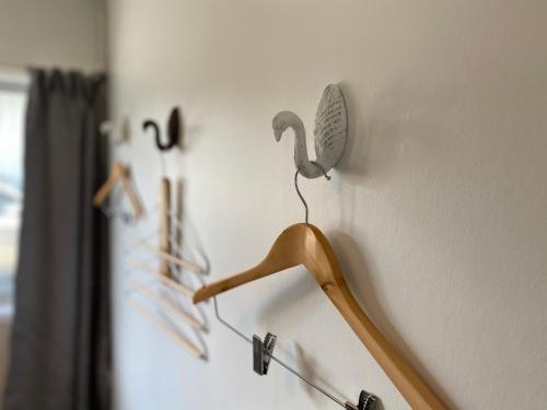 a bird decoration on a wall with a hanger at Chamberlain House - 3 bedroom house by Manly beach in Auckland
