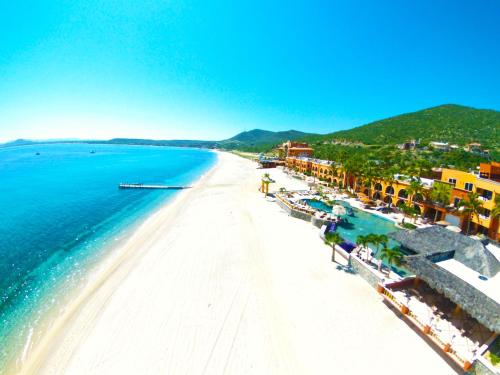 an aerial view of a beach with buildings and the ocean at Hotel Palmas De Cortez in Los Barriles