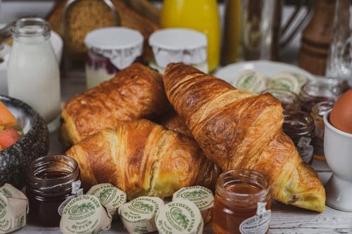 a bunch of croissants and other pastries on a table at Briery Wood Hotel in Ambleside