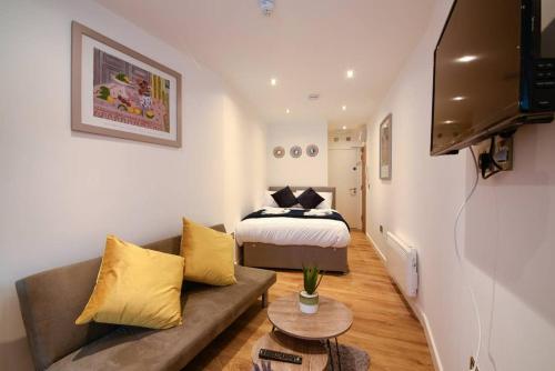 a living room with a bed and a couch at Long Row Apartments in Nottingham City Centre in Nottingham