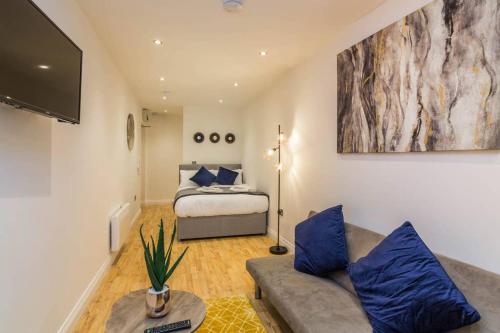 a living room with a bed and a couch at Long Row Apartments in Nottingham City Centre in Nottingham