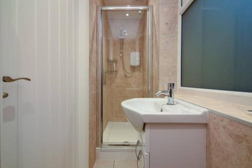 a bathroom with a sink and a shower at Long Row Apartments in Nottingham City Centre in Nottingham