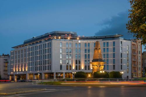 a building with a statue in front of it at Hyatt Regency Sofia in Sofia
