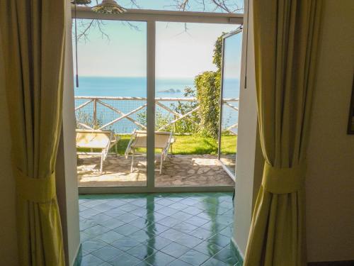 a door to a balcony with a view of the ocean at Bacio del Sole B&B Positano in Positano