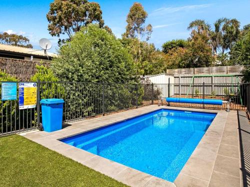 a swimming pool in a yard with a fence at A Perfect Ten in Cowes
