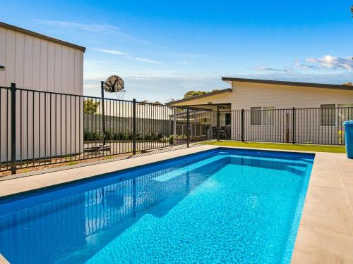 a swimming pool in front of a building at A Perfect Ten in Cowes