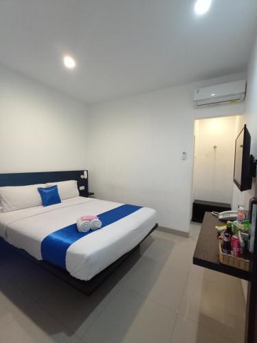 a bedroom with a bed with two towels on it at Puri Maju Hotel in Jakarta