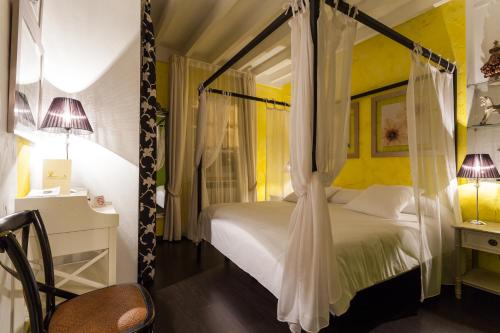 a bedroom with a white bed with a canopy at El Bosque de La Anjana in Selores