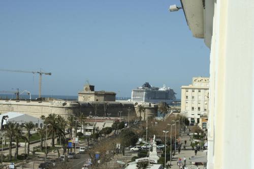 a view of a city with a cruise ship in the distance at Hotel Mediterraneo in Civitavecchia
