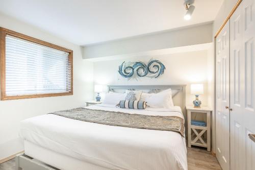 Un dormitorio blanco con una cama grande y una ventana en Calypso at Nautilus - Pet Friendly, Walk to beach! en Ocean Shores