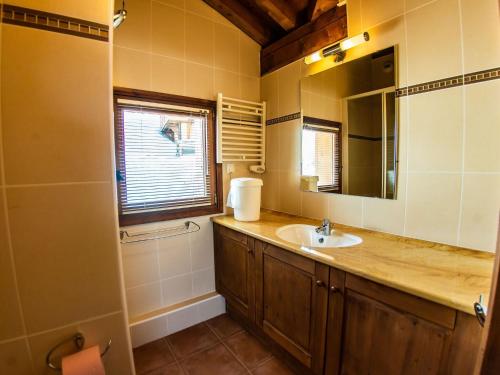 a bathroom with a sink and a mirror at Luxurious chalet near the pistes in family-friendly St François Longchamp in Saint-François-Longchamp